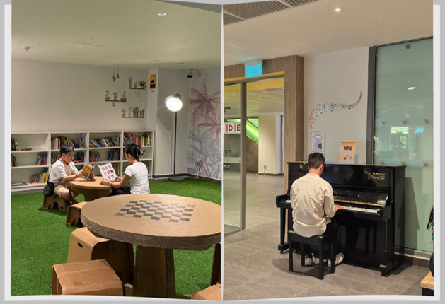Reading corner and piano area at Woodlands Hospital showing recyclable cardboard furniture, bookshelves and a donated piano
